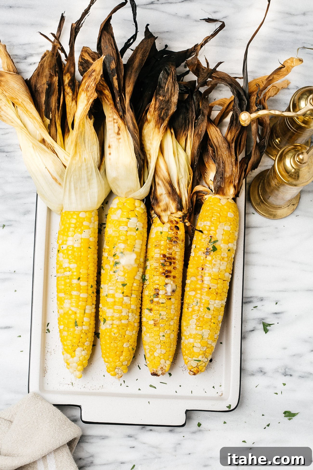 Grilled Corn Duo: From Simple to Sublime 2 overhead view of grilled corn on a white serving dish