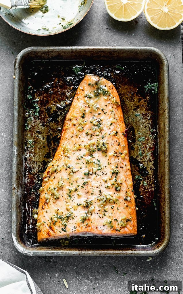 An overhead view of a beautifully baked salmon fillet on a baking sheet, ready to enjoy.