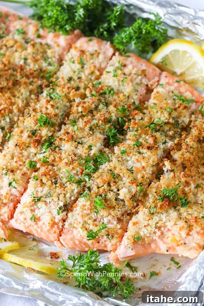 An overhead view of a herb-crusted salmon fillet, beautifully baked on a baking sheet.