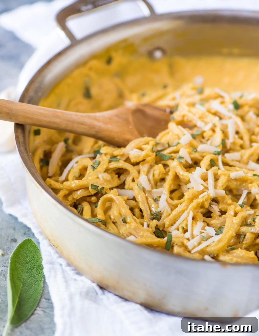 The Ultimate Fall Pumpkin Sauces 8 A large skillet brimming with fettuccine noodles enveloped in a luscious, creamy pumpkin sauce, garnished with grated parmesan cheese and fresh herbs.