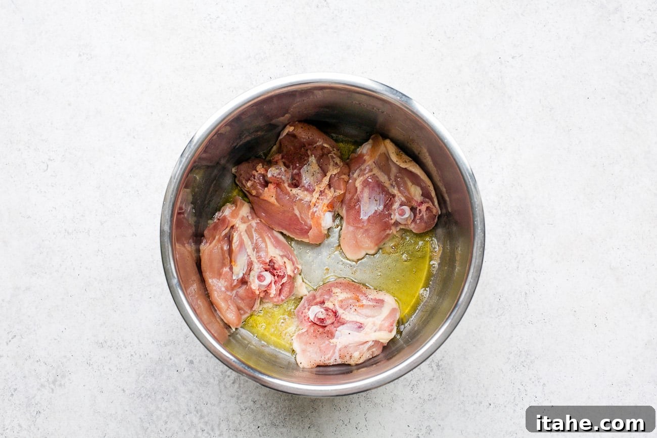 Searing bone-in, skin-on chicken thighs in the Instant Pot for Instant Pot Chicken Noodle Soup.