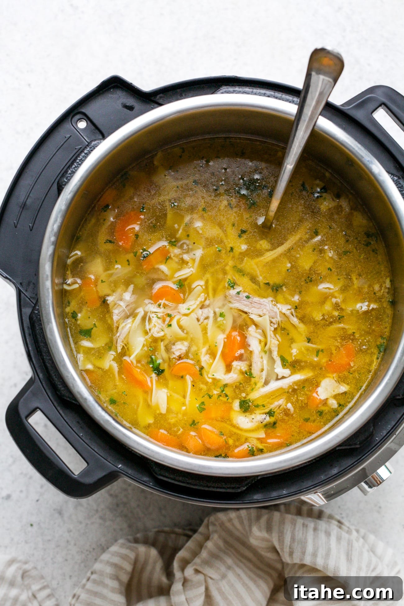 The finished Instant Pot chicken noodle soup simmering in the Instant Pot, ready to serve.