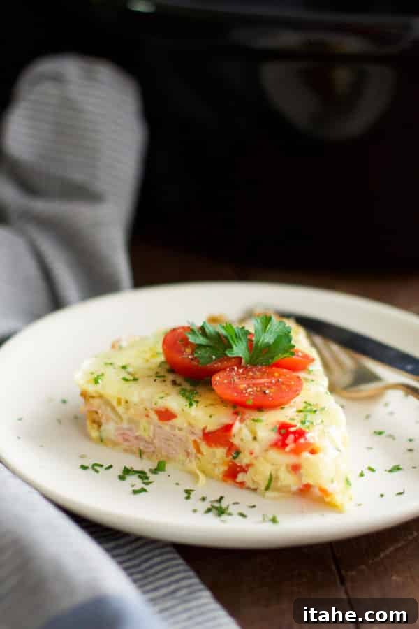 Christmas Morning Slow Cooker Omelet with ham, cheese, and vegetables, ready to serve for an easy festive breakfast.