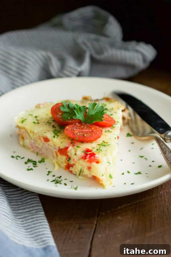A festive Christmas Morning Slow Cooker Omelet with fresh herbs and cherry tomatoes, ready for serving.