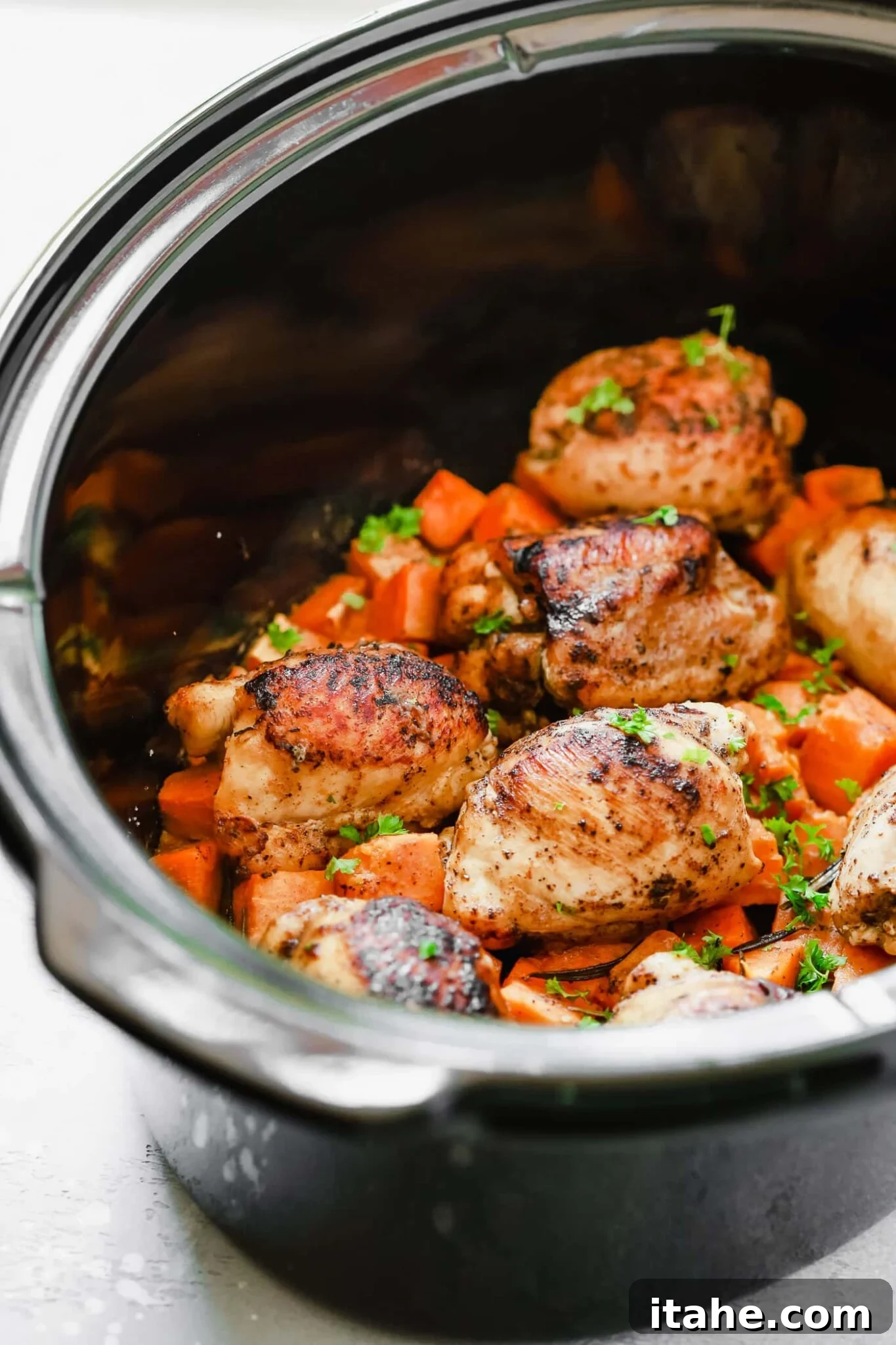 raw chicken thighs and sweet potato in a crockpot