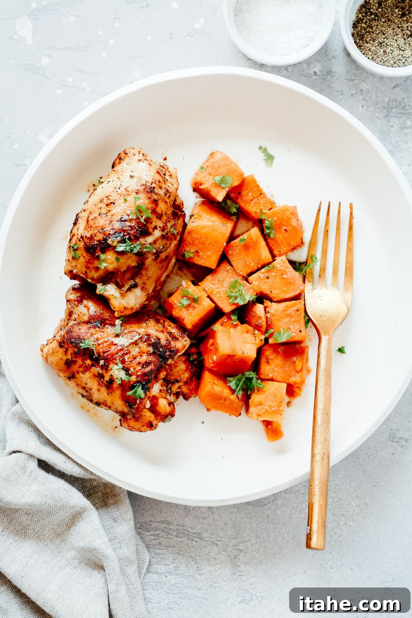 Overhead view of sweet potato and chicken thighs