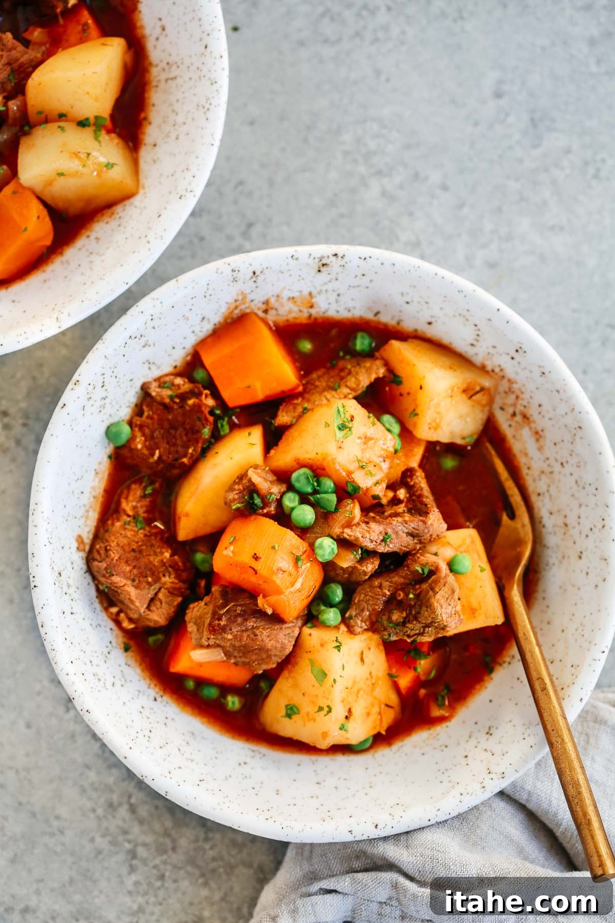 Nourishing Slow Cooker Beef Stew 5 White bowl with healthy slow cooker beef stew inside, ready to be served.
