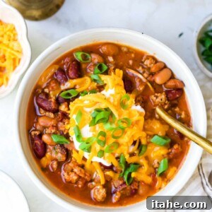 A bowl of delicious classic chili with toppings