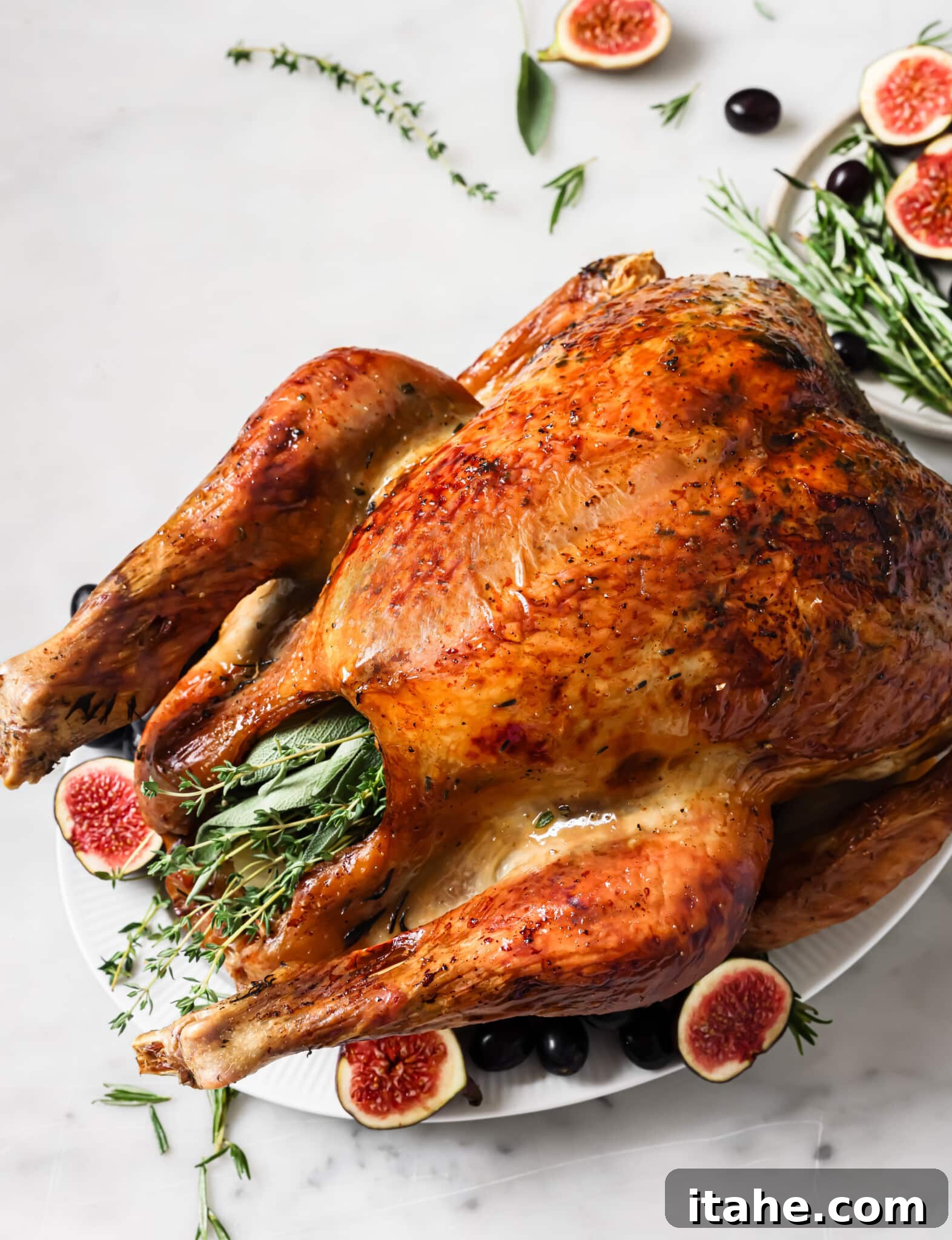 Garlic butter roasted turkey on a serving platter. 