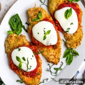 Crispy Baked Chicken Parmesan 8 Overhead view of baked chicken parmesan on a white plate