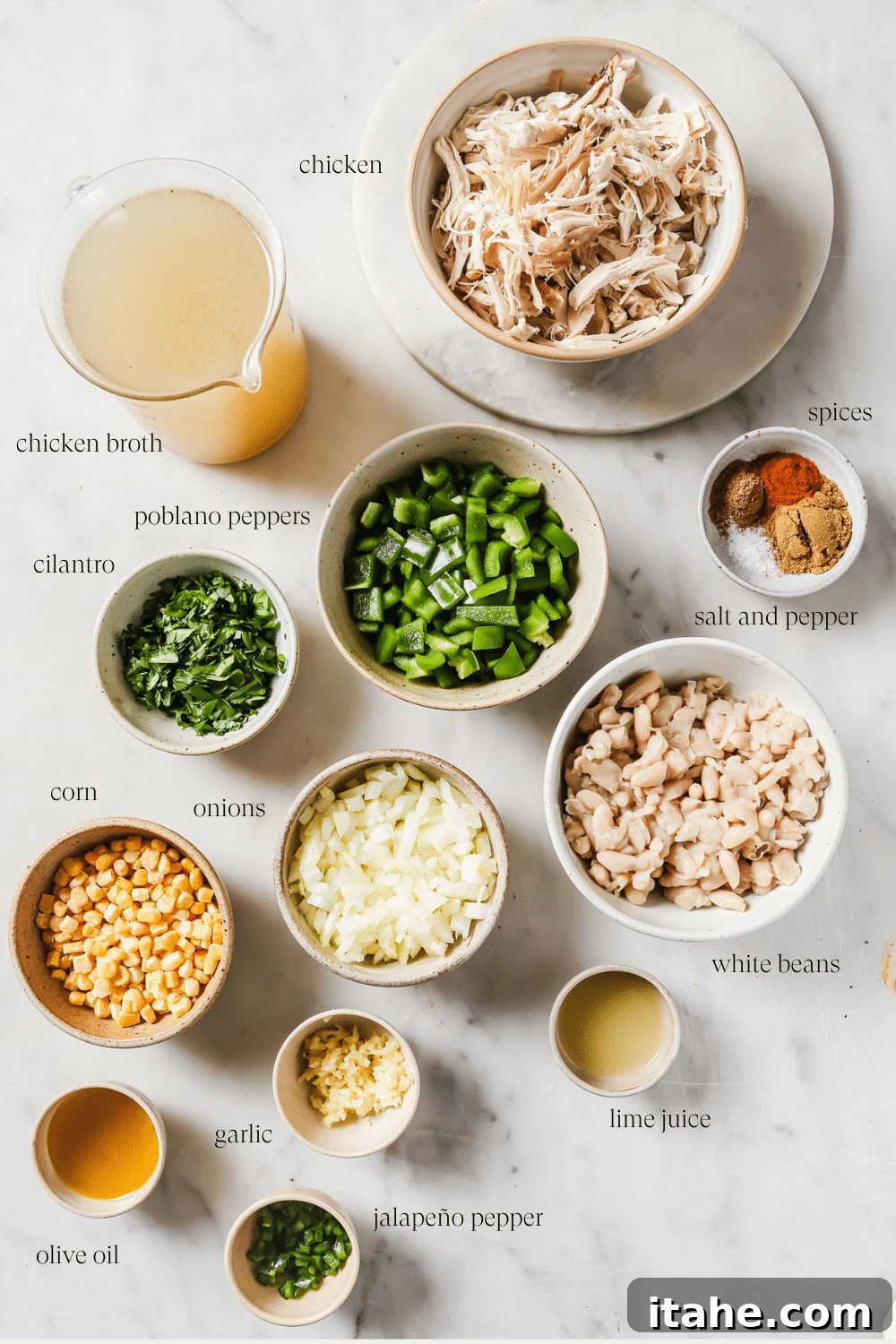 Assortment of pre-measured ingredients like beans, spices, and chopped vegetables neatly arranged in small bowls, ready for making White Chicken Chili.