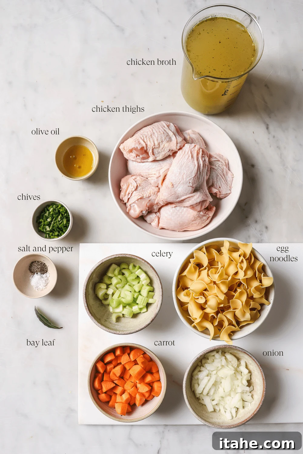 Pre-measured ingredients for slow cooker chicken noodle soup laid out in small bowls.