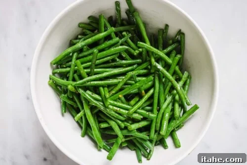Perfectly Crispy Air Fryer Green Beans 11 Air Fryer Green Beans in a white bowl