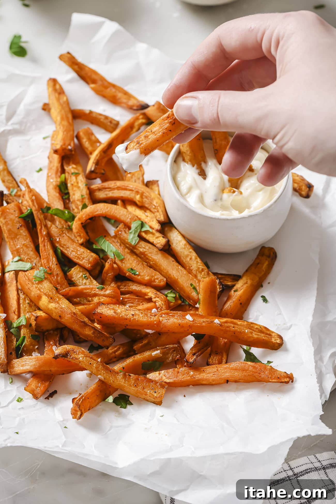Perfectly Crispy Air Fryer Sweet Potato Fries 8 Air fryer sweet potatoes with dipping sauce on the side.