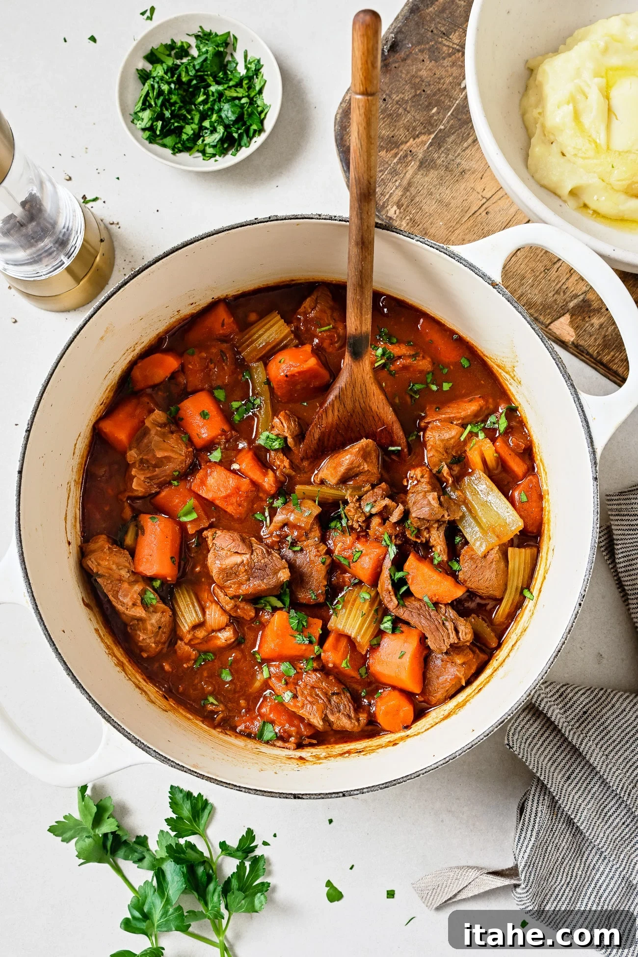 Hearty Lamb Stew 7 Lamb stew in a white Dutch oven.