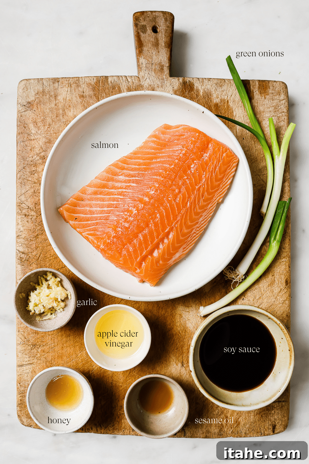 Golden Air Fryer Salmon Bites 3 Pre-measured ingredients for salmon bites displayed on a wooden cutting board.