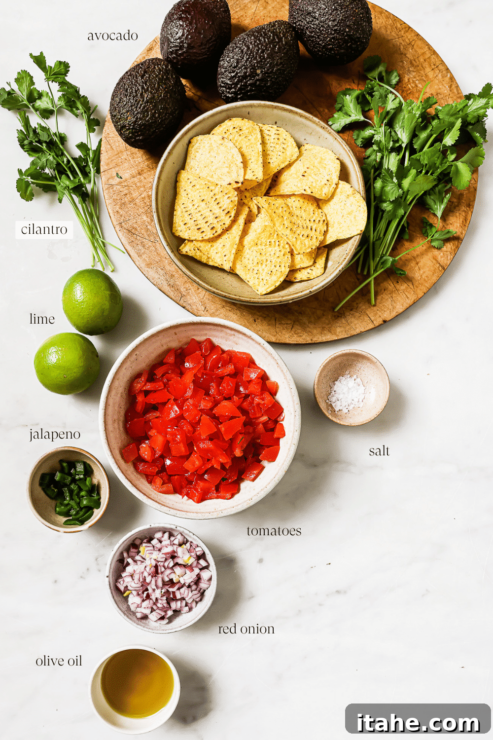 Pre-measured, fresh ingredients for making avocado salsa arranged on a countertop.
