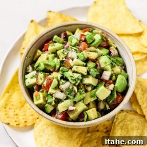 Freshly made avocado salsa in a bowl with tortilla chips