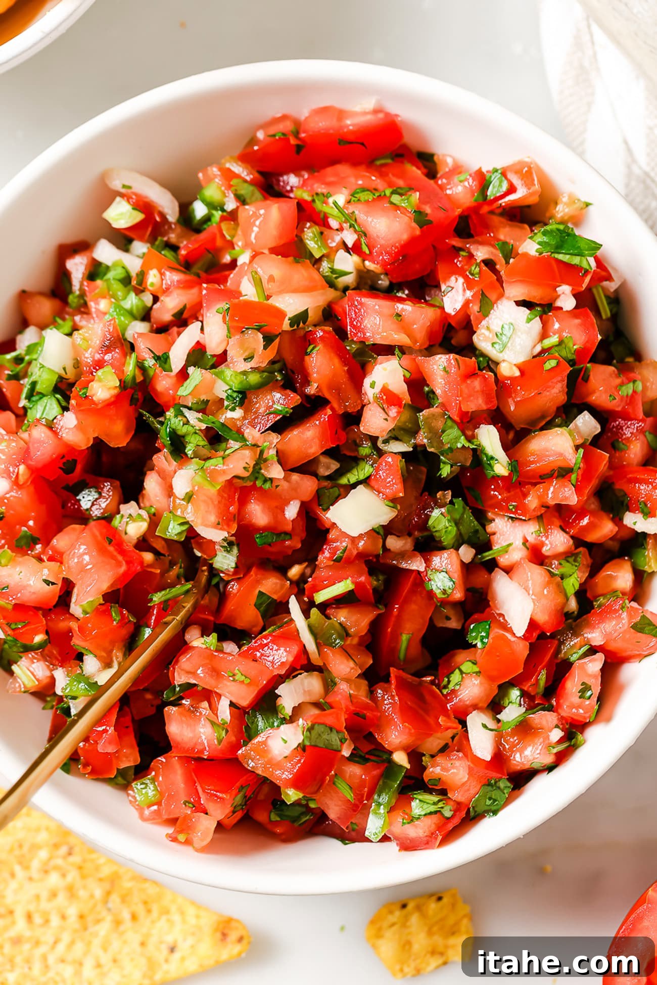 An overhead view of pico de gallo in a large bowl.