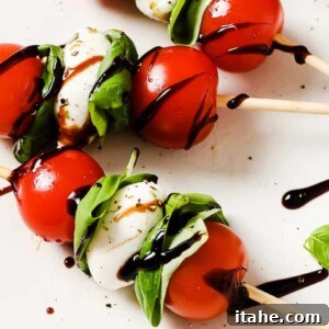close up of caprese skewers on a white plate