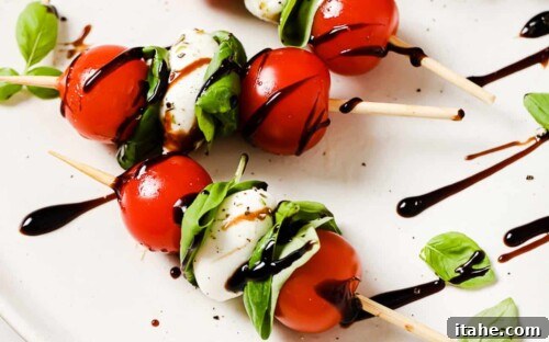 close up of caprese skewers on a white plate