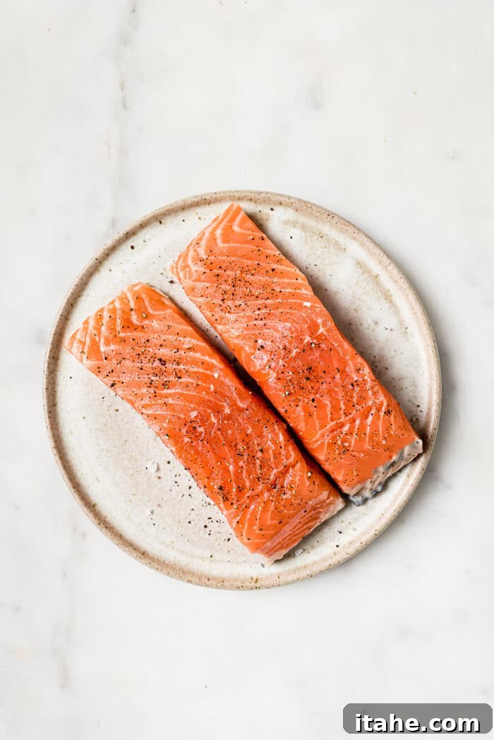 Garlic Honey Glazed Salmon 5 A plate of two salmon fillts on a white countertop.