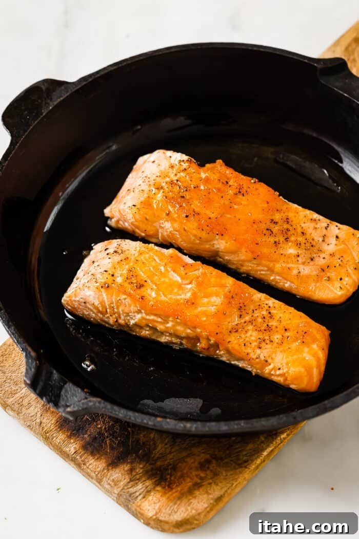 Garlic Honey Glazed Salmon 6 Two pieces of salmon in a cast iron skillet.