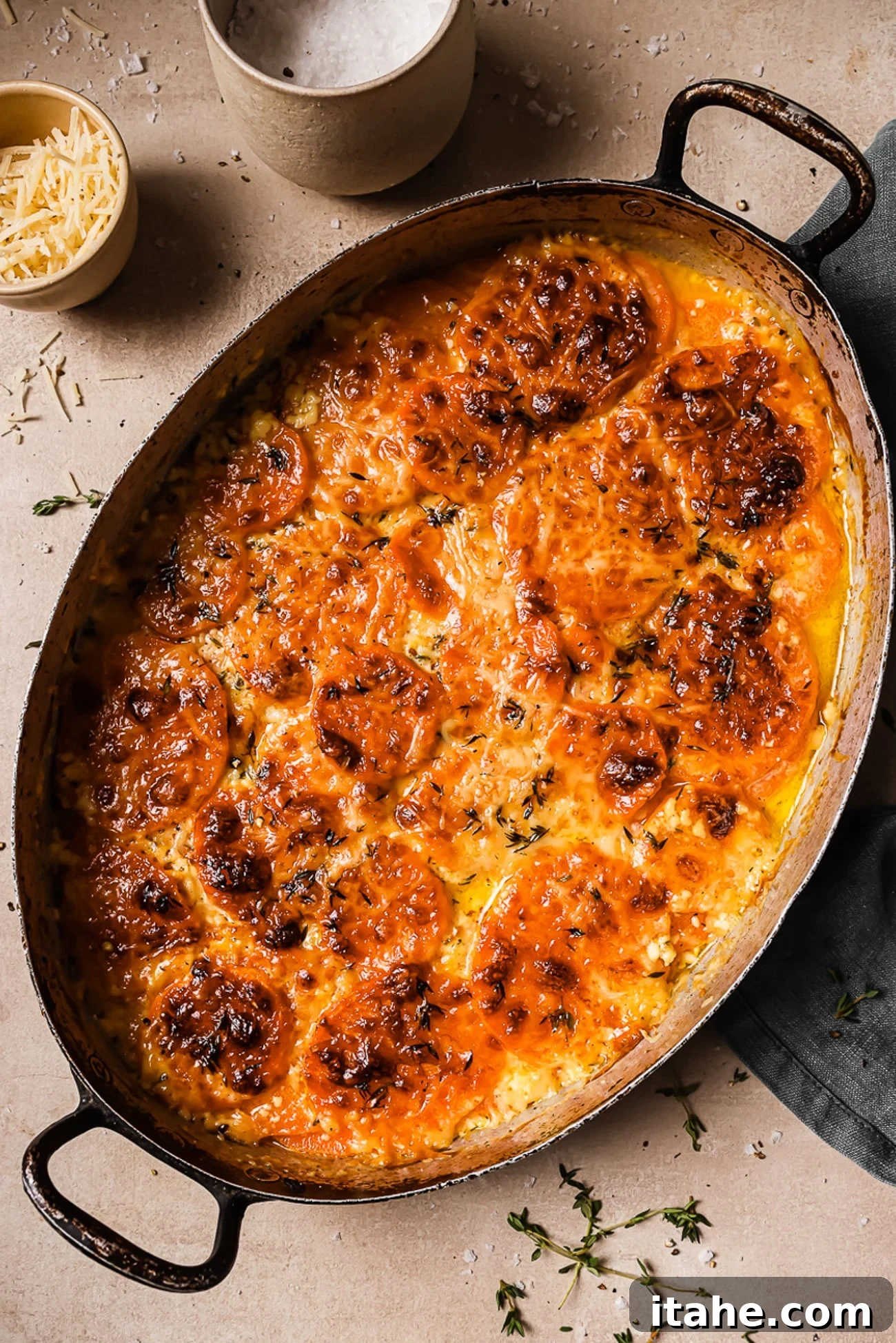An overhead view of a beautifully baked sweet potato gratin in an oval baking dish, showcasing its perfect golden crust.