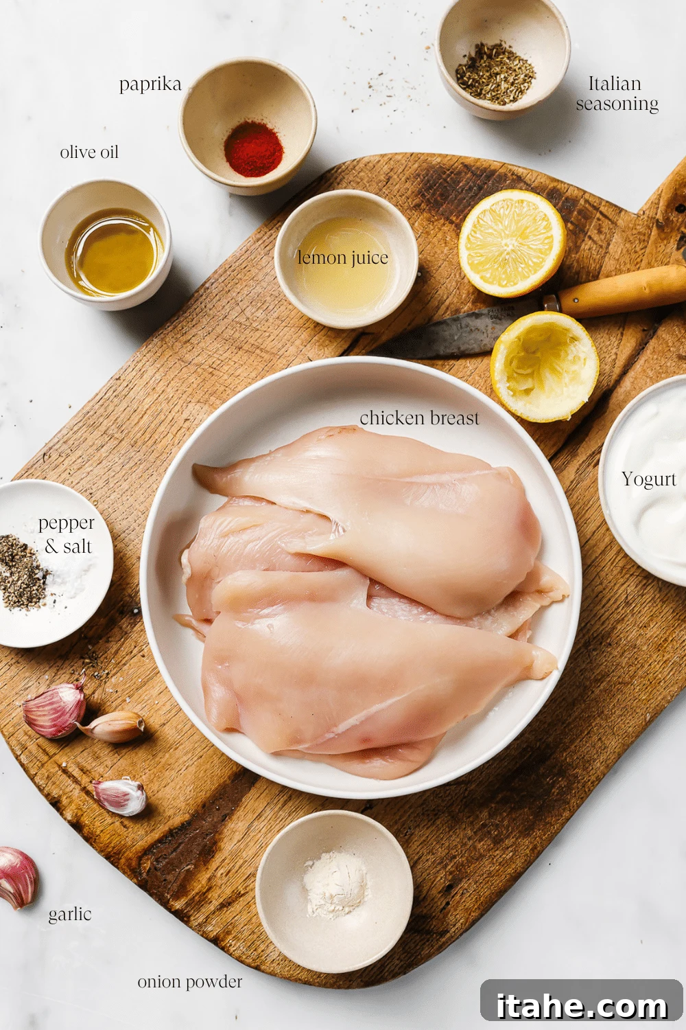 Creamy Yogurt Chicken Breasts 3 Pre-measured ingredients on a wooden cutting board with text overlay for each ingredient.