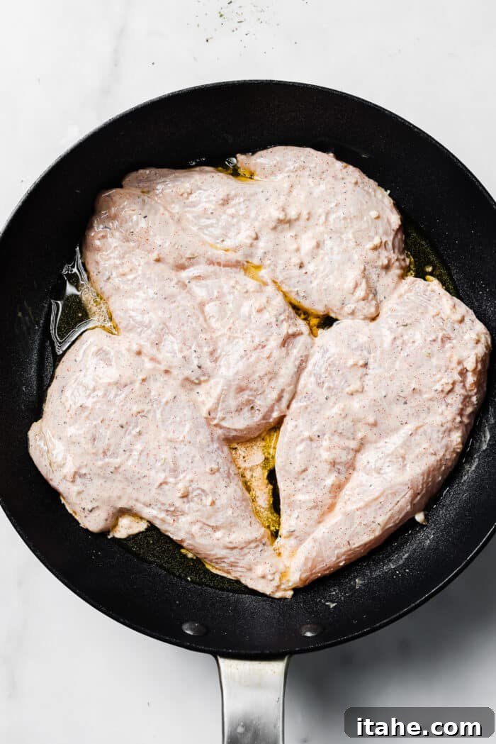 Creamy Yogurt Chicken Breasts 6 Four yogurt-marinated chicken breasts in a hot skillet.