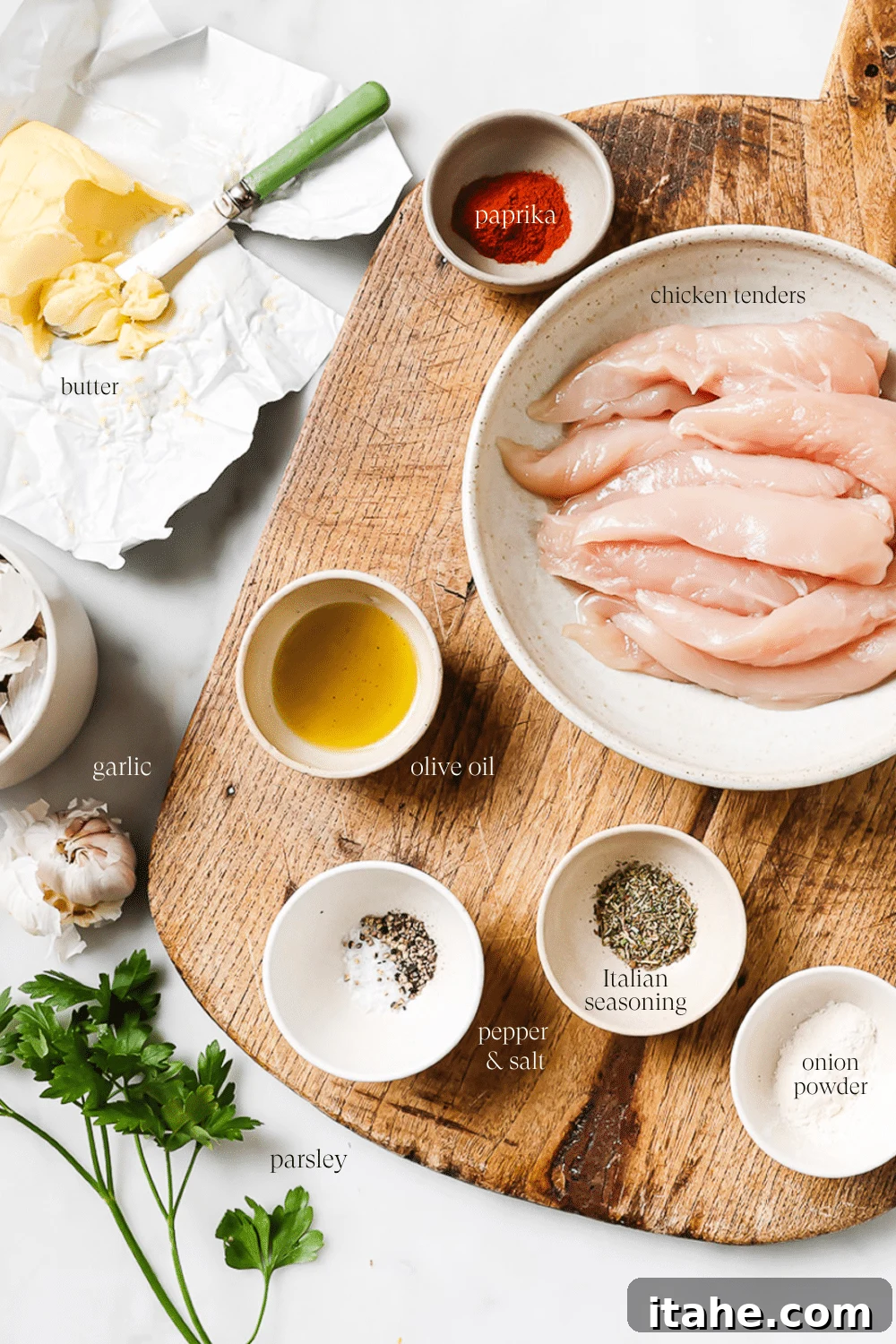 Pre-measured ingredients for garlic butter chicken tenders in small bowls with text overlay for each ingredient. 
