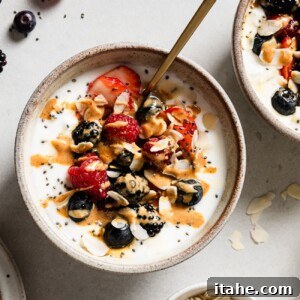 A cottage cheese and Greek yogurt breakfast bowl topped with berries, a delicious and quick meal.
