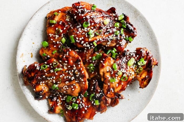 Teriyaki marinated chicken on a white serving plate. 