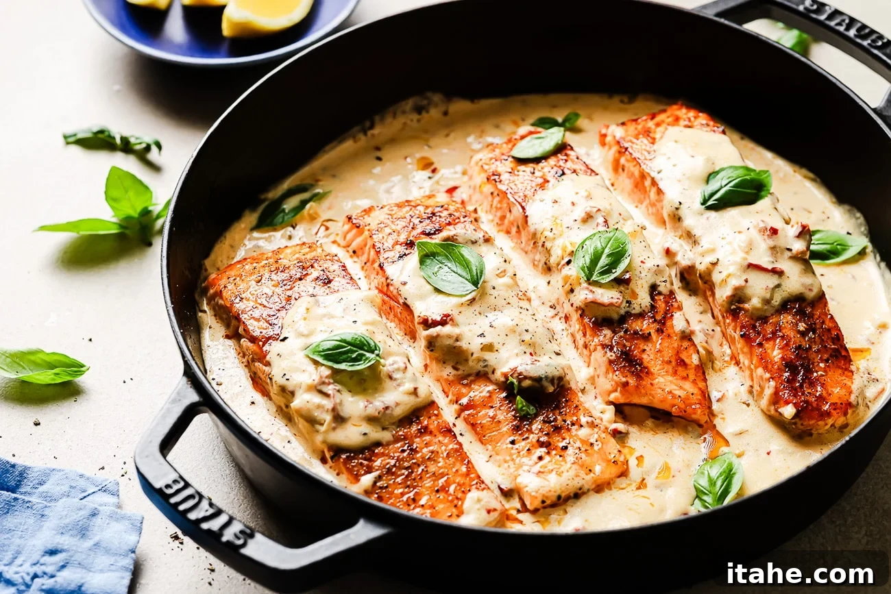Overhead view of Marry Me Salmon in a cast-iron skillet, ready to serve with a garnish of fresh basil.