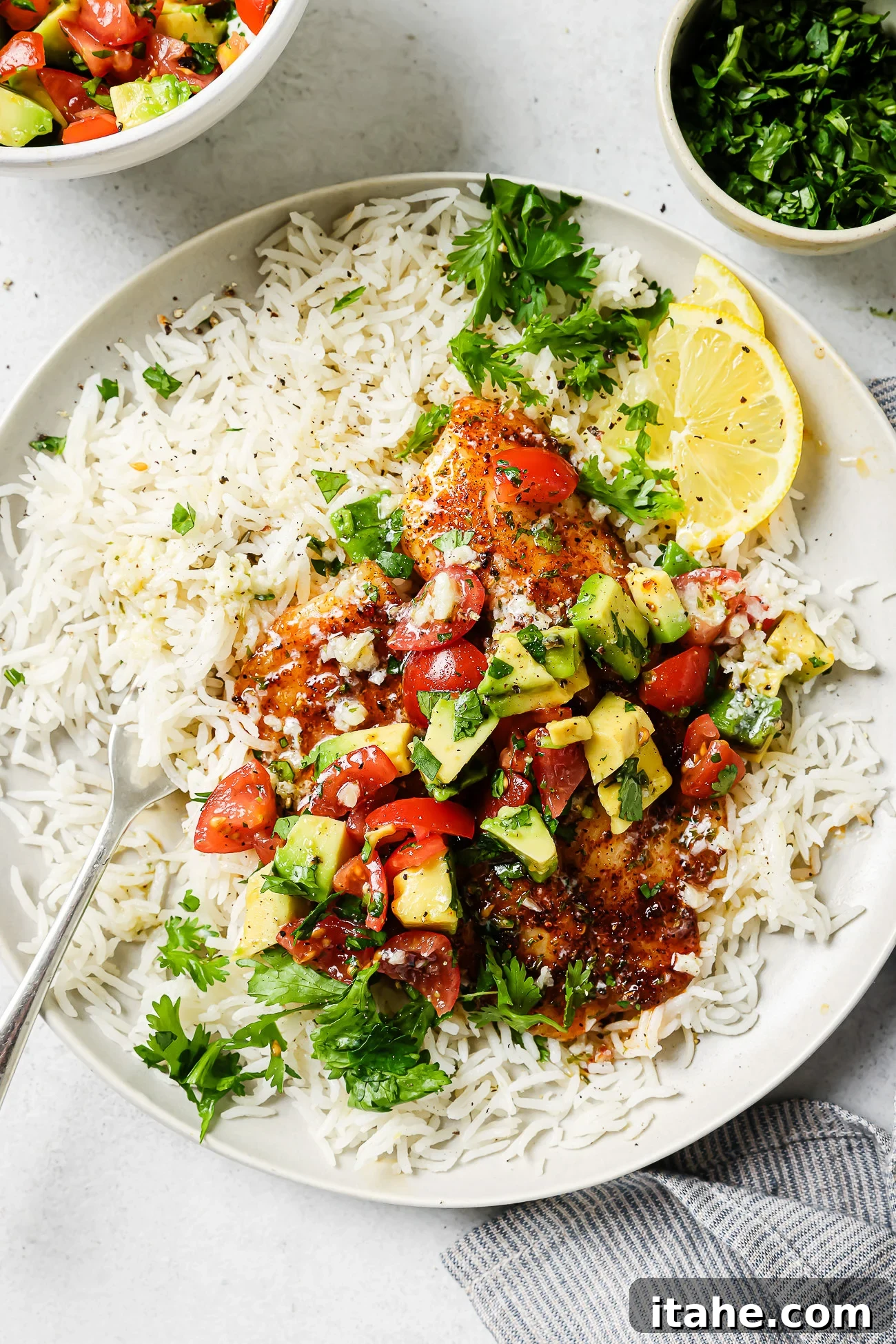 Cooked air fryer tilapia fillet on a plate with rice and pico de gallo. 🌮🍚🐟