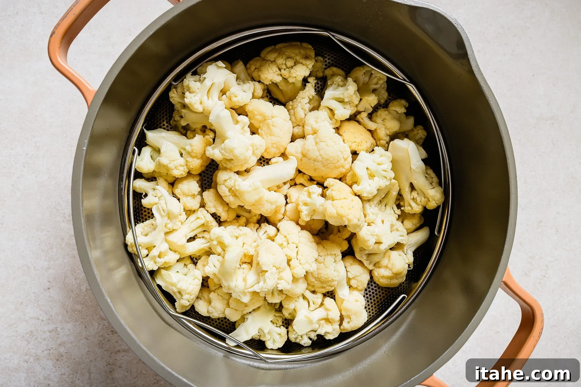 Crispy Roasted Air Fryer Cauliflower 8 Clean cauliflower florets in a steamer basket, drying after washing.