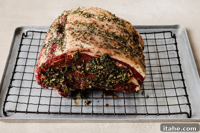 seasoned roast on a wire rack set inside a baking sheet. 