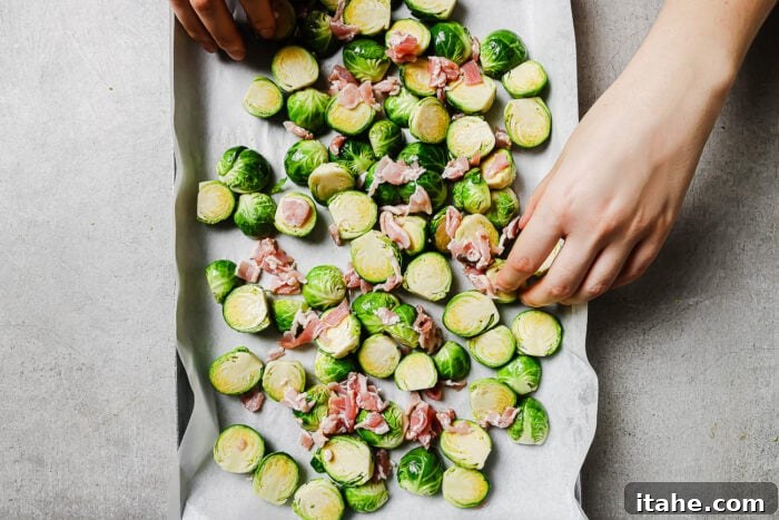 Caramelized Maple Bacon Brussels Sprouts 6 Halved Brussels sprouts and chopped bacon spread on a parchment-lined baking sheet.