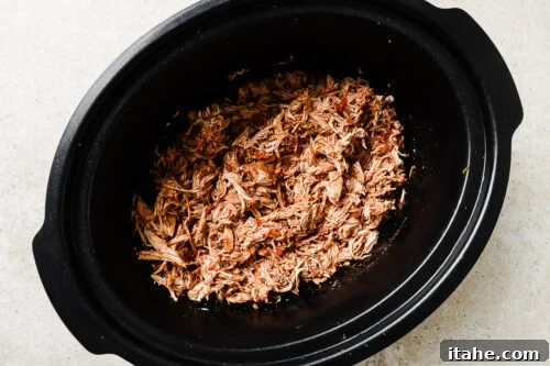 sheredded chicken inside the slow cooker